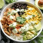 Slow Cooker Chicken Burrito Bowl with rice, beans, corn, avocado, and cilantro lime dressing