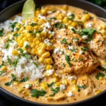 Slow Cooker Street Corn Chicken served with rice, corn, cotija cheese, and fresh cilantro in a creamy sauce.