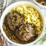 Hearty Slow Cooker Salisbury Steaks with mushroom gravy and egg noodles