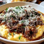 Short Rib Ragu with Parmesan Mashed Potatoes in a white bowl, topped with shredded Parmesan and parsley.