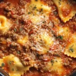 Slow cooked Crockpot Ravioli Lasagna with meat sauce, cheese, and tender ravioli in a rich tomato base.