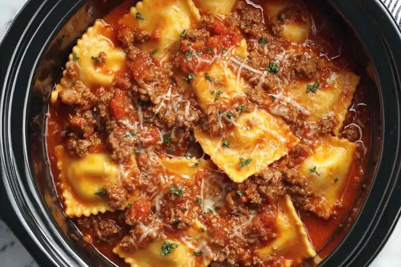 Crockpot Ravioli Lasagna with layers of cheese ravioli, rich meat sauce, and melted cheese cooked in a slow cooker.