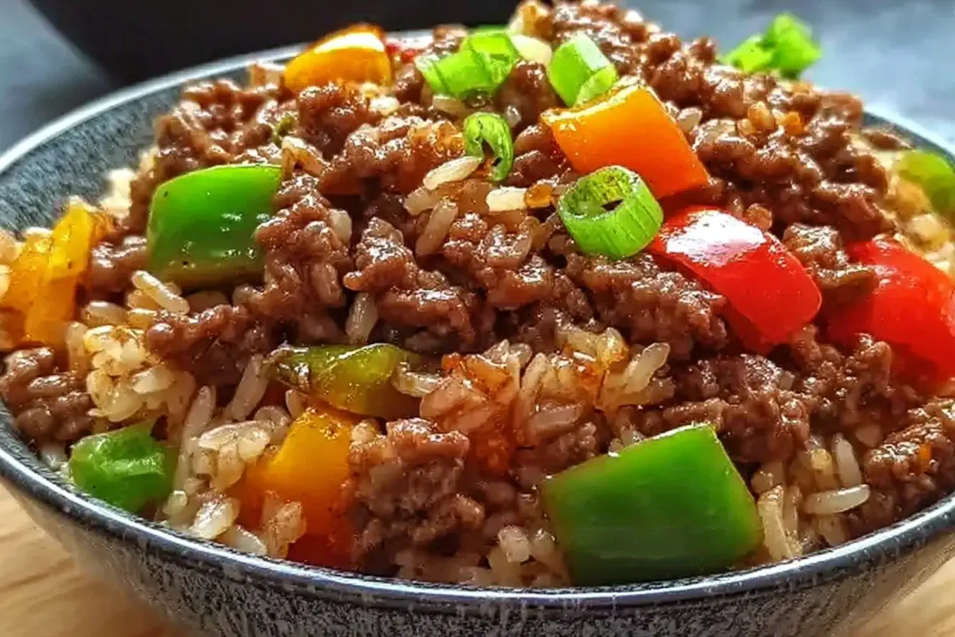 Close-up of a Beef Pepper Rice Bowl with ground beef, colorful bell peppers, and jasmine rice topped with green onions.