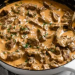 Creamy Gordon Ramsay Beef Stroganoff in a skillet with tender beef, rich mushroom sauce, and fresh parsley garnish.