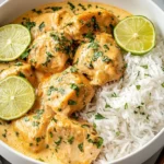 Crockpot Coconut Lime Chicken served with fluffy white rice and fresh lime slices in a creamy coconut sauce.