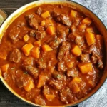 Dutch oven filled with Autumn Harvest Beef Stew featuring tender beef, butternut squash, and a rich fall-inspired broth.
