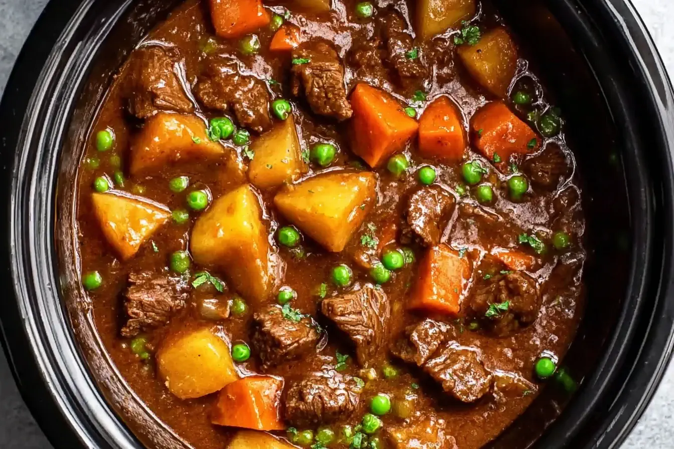 Wholesome Crockpot Beef Stew with tender beef, potatoes, carrots, and peas simmered in a flavorful slow-cooked broth.