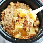 Spoonful of warm Crock Pot Apple Dump Cake from slow cooker