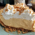 Slice of Amish Peanut Butter Cream Pie with thick peanut butter filling, whipped topping, and crunchy crumble crust.