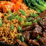 Slow Cooker Beef Ramen Noodles with tender beef, ramen noodles, sesame seeds, and green onions in a cozy bowl.
