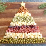 Simple Christmas Tree Charcuterie Board with mixed cheeses, salami, and olives arranged like a tree