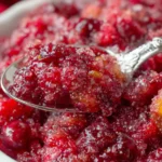 Spoonful of fruity cranberry mixture highlighting texture for a Cranberry Jello Salad Recipe
