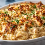 Creamy French Onion Chicken Orzo Casserole topped with golden melted cheese and fresh herbs.