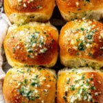 Soft and fluffy Garlic Bread Rolls brushed with melted garlic herb butter and sprinkled with fresh parsley and flaky salt.