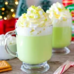 Grinch Hot Chocolate topped with whipped cream and mini marshmallows