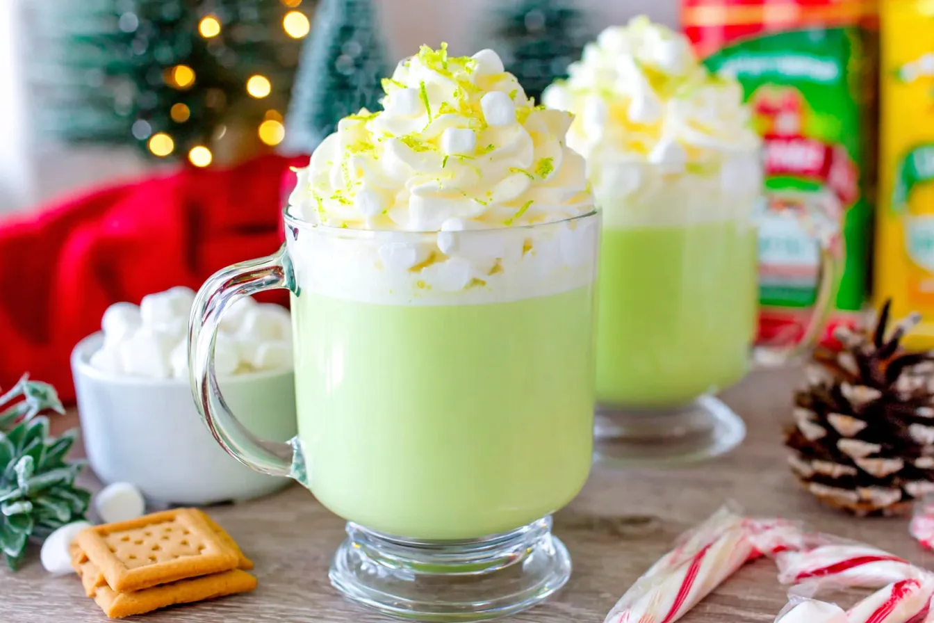 Grinch Hot Chocolate topped with whipped cream and mini marshmallows