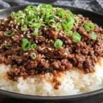 Korean Ground Beef Bowl served over steamed rice with sesame seeds and green onion garnish.
