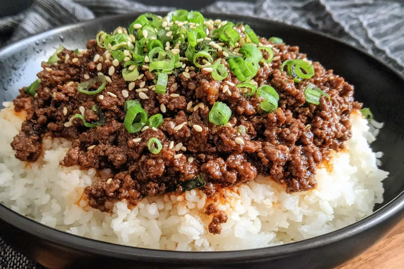 Korean Ground Beef Bowl served over steamed rice with sesame seeds and green onion garnish.