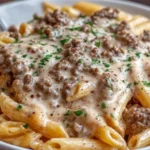 Slow Cooker Creamy Garlic Beef Pasta with tender beef, creamy garlic sauce, and parsley served over penne pasta
