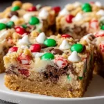 Christmas Cookie Bars topped with red and green candies and white chocolate chips, showing a soft, chewy holiday dessert cut into squares.