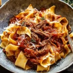 Slow Cooker Italian Beef Ragu served over pappardelle pasta with Parmesan and fresh herbs