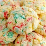 Soft and chewy Christmas Gooey Butter Cookies with red and green sprinkles on a plate, dusted with powdered sugar.