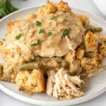 Plate of Crockpot Chicken and Stuffing with tender shredded chicken, creamy gravy, and golden stuffing cubes.