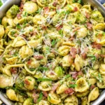 Brussels Sprouts and Bacon Pesto Pasta served in a skillet with parmesan and herbs