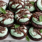 Chocolate Mint Cookies arranged on a tray with mint frosting and chocolate drizzle