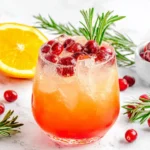 Christmas Punch garnished with cranberries, rosemary, and fresh orange slices