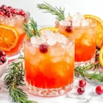 Christmas Punch in festive glasses with cranberries, oranges, and ice