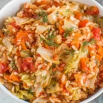 Greek Rice And Cabbage with rice, cabbage, tomatoes, carrots, and fresh herbs served in a bowl