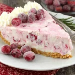 No-Bake Cranberry Cream Pie slice topped with whipped cream and sugared cranberries