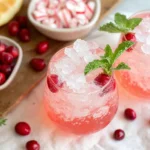 Peppermint Mocktail in glasses with crushed ice, fresh cranberries, and mint garnish