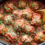 Slow CoSlow Cooker Italian Meatballs simmering in rich tomato sauce with fresh parsley and parmesan cheeseoker Italian Meatballs 2
