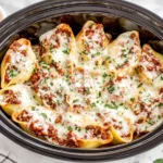 Slow Cooker Stuffed Shells with meat baked in sauce and melted cheese inside the slow cooker
