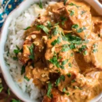 Slow Cooker Thai Peanut Chicken served over white rice with chopped peanuts and cilantro