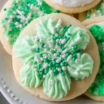 Soft Sugar Cookies decorated with mint green frosting and winter sprinkles