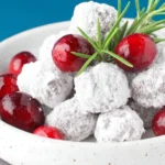 Candied Cranberries with rosemary garnish on a ceramic plate