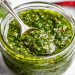 Zhoug Sauce stored in a glass jar, showing a fresh, herby green sauce texture