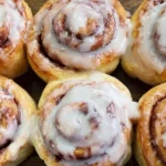 Gluten Free Cinnamon Rolls topped with creamy icing, baked until golden and soft, arranged closely for a cozy homemade breakfast treat