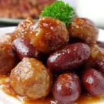 Crockpot Meatballs and Little Smokies served on a plate, coated in a glossy sweet barbecue sauce, perfect for easy party appetizers