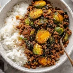 Ground Beef and Brussels Sprouts served over fluffy white rice in a bowl, featuring caramelized Brussels sprouts and savory seasoned ground beef.