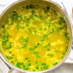 10 Minute Immune Boosting Broth simmering in a pot with green onions