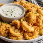Air Fryer Banana Peppers piled on a plate with creamy dipping sauce