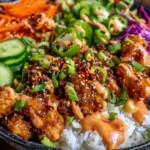 Bang Bang Chicken Bowl with crispy chicken, jasmine rice, fresh vegetables, and creamy spicy sauce