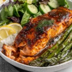 Cajun Brown Sugar Salmon served with rice, asparagus, and fresh salad
