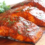 Cajun Brown Sugar Salmon fillets with caramelized glaze on a wooden board
