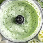 Creamy Garlic Lime Cilantro Sauce blended smooth in a food processor