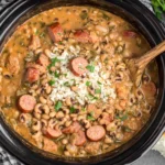 Crock Pot Hoppin' John with black-eyed peas, smoked sausage, and rice in a slow cooker